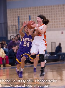 Burbank guard Alejandra Martinez secures a loose ball as Brack's Miranda Acuna charges in to gain possession.