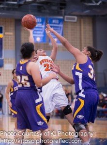 Burbank's Olivia Cardenas tries to loft a fadeway jumper over two Brackenridge defenders.