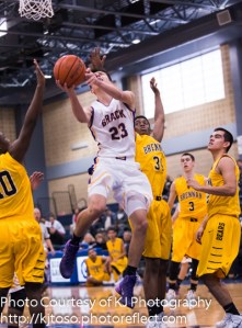 Brack sophomore Richard Wallace (23) weaves through Brennan's defense.