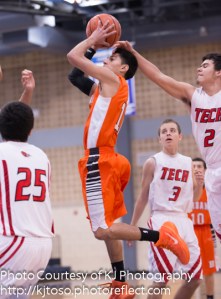 Burbank's Gabriel Rangel aims for a basket, despite the block attempt.