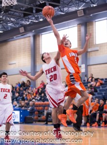 Burbank's Christian Fonseca (5) eludes Fox Tech's Gabriel Tirado (20) on the way to the basket.