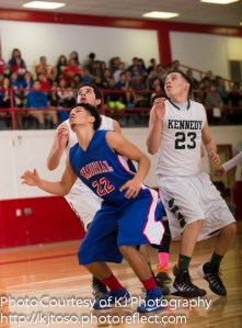 Daniel Flores (22) of Memorial establishes rebounding position against a pair of Kennedy players, including Jose Espinoza (23).