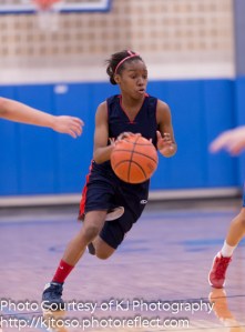 YWLA's Karese Williams drives toward two of her nine points.