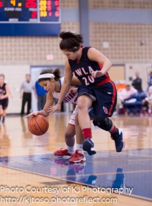 Jefferson's Sasha Barrientos corrals a loose ball as YWLA's Abigail Moreno takes a swipe.