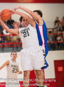 Kennedy junior Isaac Castro (21) hauls in a rebound against Memorial.