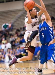 Highlands point guard Jamaria Moody goes airborne to get off a shot against tight defense from Lanier junior Carlos Gutierrez.