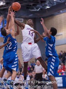 Jefferson's D'Andre Melton (14) fights for a rebound against two Lanier players.