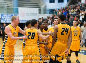 His East Central teammates celebrate Jeremy Jones' game-winning dunk.