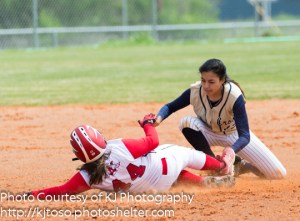 Holy Cross second baseman Erin Torralva applies the tag to an Incarnate Word baserunner after receiving a strong throw from center fielder Omni Garcia.