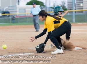 East Central third baseman Alexis Macias receives a throw from the outfield as a Southwest runner slides into the base.
