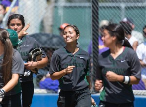 Teammates congratulate Gabby Flores after her three-run home run in the third inning.