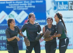 Kristal Salinas, Faith Aguilar, Amanda Sanchez and Yanira Fernandez (from left to right) share their enthusiasm over a remarkable catch. Salinas backpedaled to the outfield grass to corral the ball, but it popped out of her glove. Sanchez caught the ball in the air for the key out in the sixth inning. 