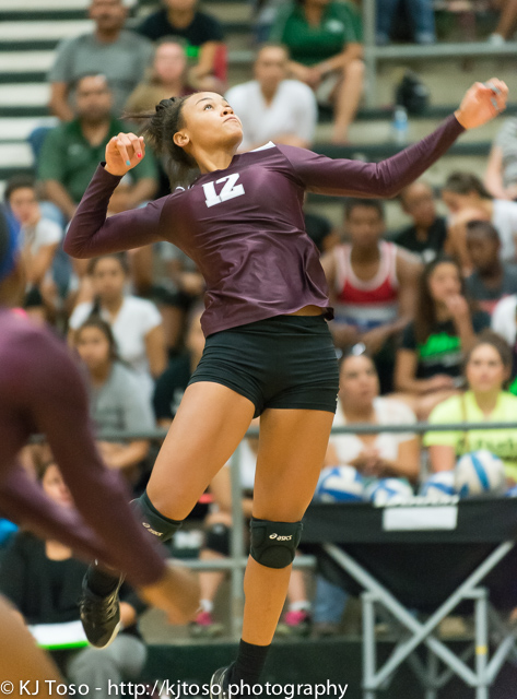 Jazmine Jackson, a powerful hitter for Highlands, goes up to punch one of her 8 kills.