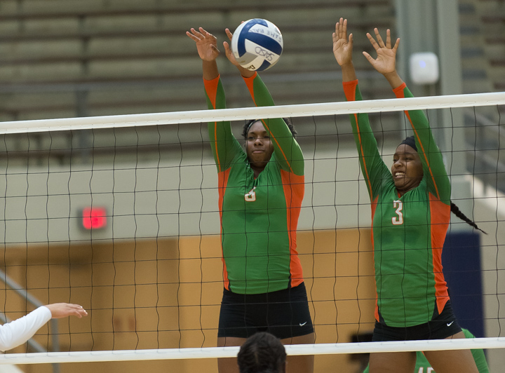 Karisma Mitchell (8) and Natalie Coburn (3) go up for a block against Burbank