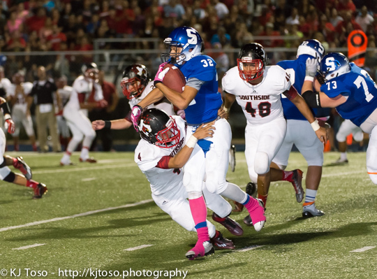 Southside freshman Johnny Herrera (4) gets a Somerset runner in his grasp while Toby Segura Jr. (40) closes in to finish the play in a key regular season game for the Cardinals.