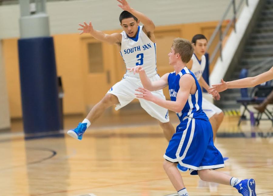 South San guard Justin Apolinar goes airborne to cut down MacArthur standout Kyle Murphy's passing lanes in a Thursday first-round game.