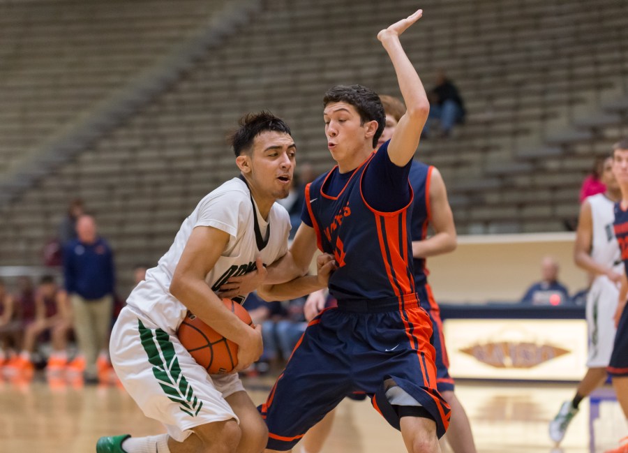 Dragons sophomore Tristan Quintana drives to score two of his 10 points against Brandeis.
