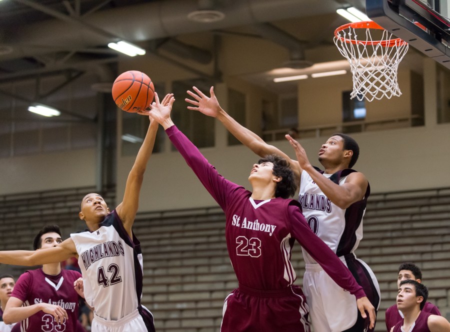 Highlands' Christopher Hartfield (42) tips a rebound away from St. Anthony's Asa Meyer (23).