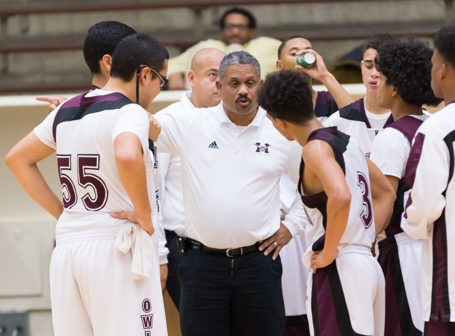 Highlands coach Rufus Lott discusses strategy with his team in the Owls' 62-60 win over St. Anthony.