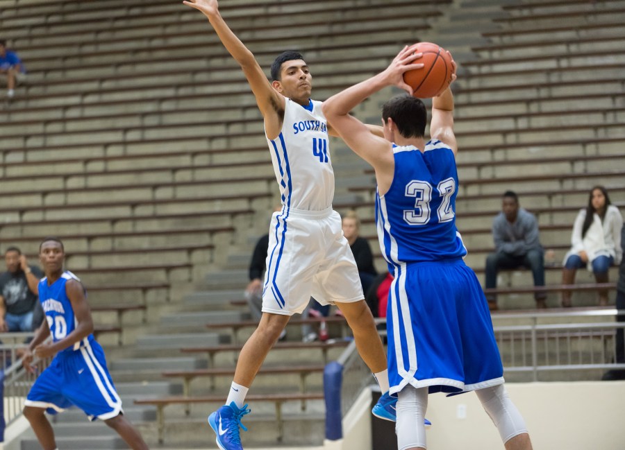 Joseph Zepeda (41) of South San defends an inbound pass from MacArthur's Shawn Hamilton.
