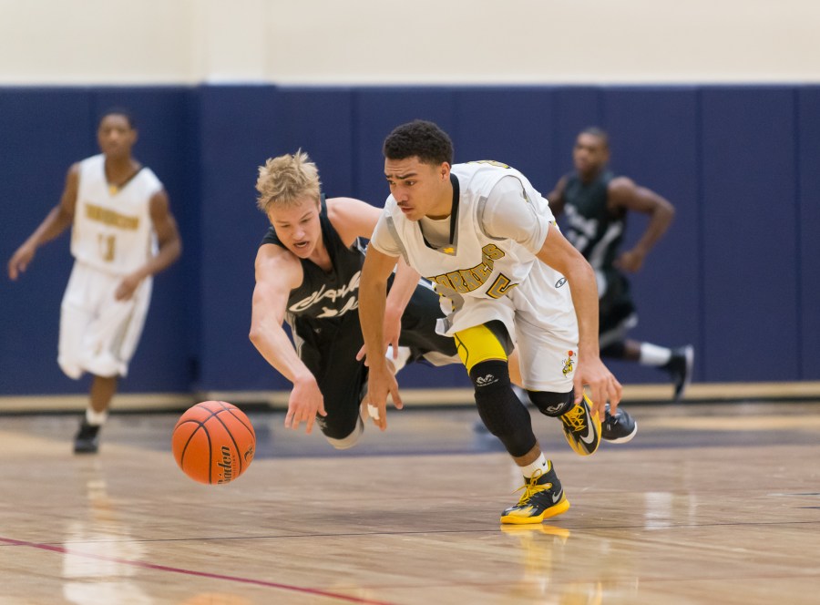 Brandon Keno and Clak's Micah Damrow (11) race for a loose ball.