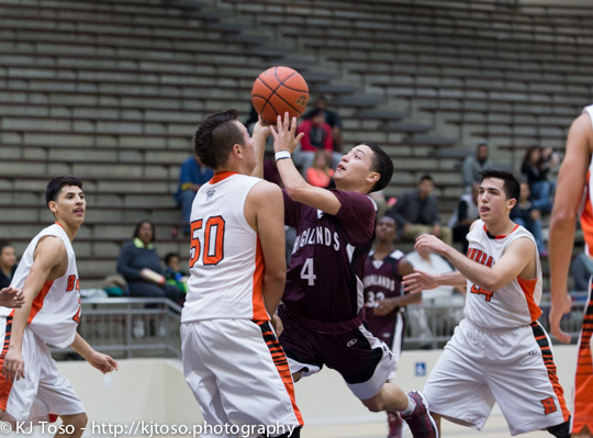 Highlands guard Jose Alvarez (4) drives on Burbank post William Valdez (50).