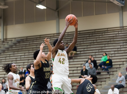 Sam Houston post Devin Allen (42) clears a rebound over Edison's Andrew Rodriguez (5) while the Golden Bears' Lorenzo Vela closes in.