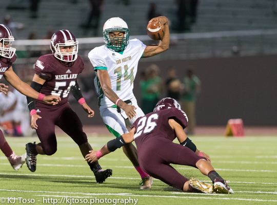 Sam Houston receiver Jawon Anderson (14) tries to escape heavy pursuit from Highlands senior Joseph Mangaccat (26) and Brandon Medina (54). Anderson logged 116 reception yards and 2 touchdowns.